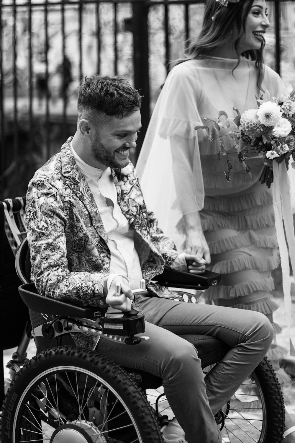 a man sitting in a wheel chair next to a woman