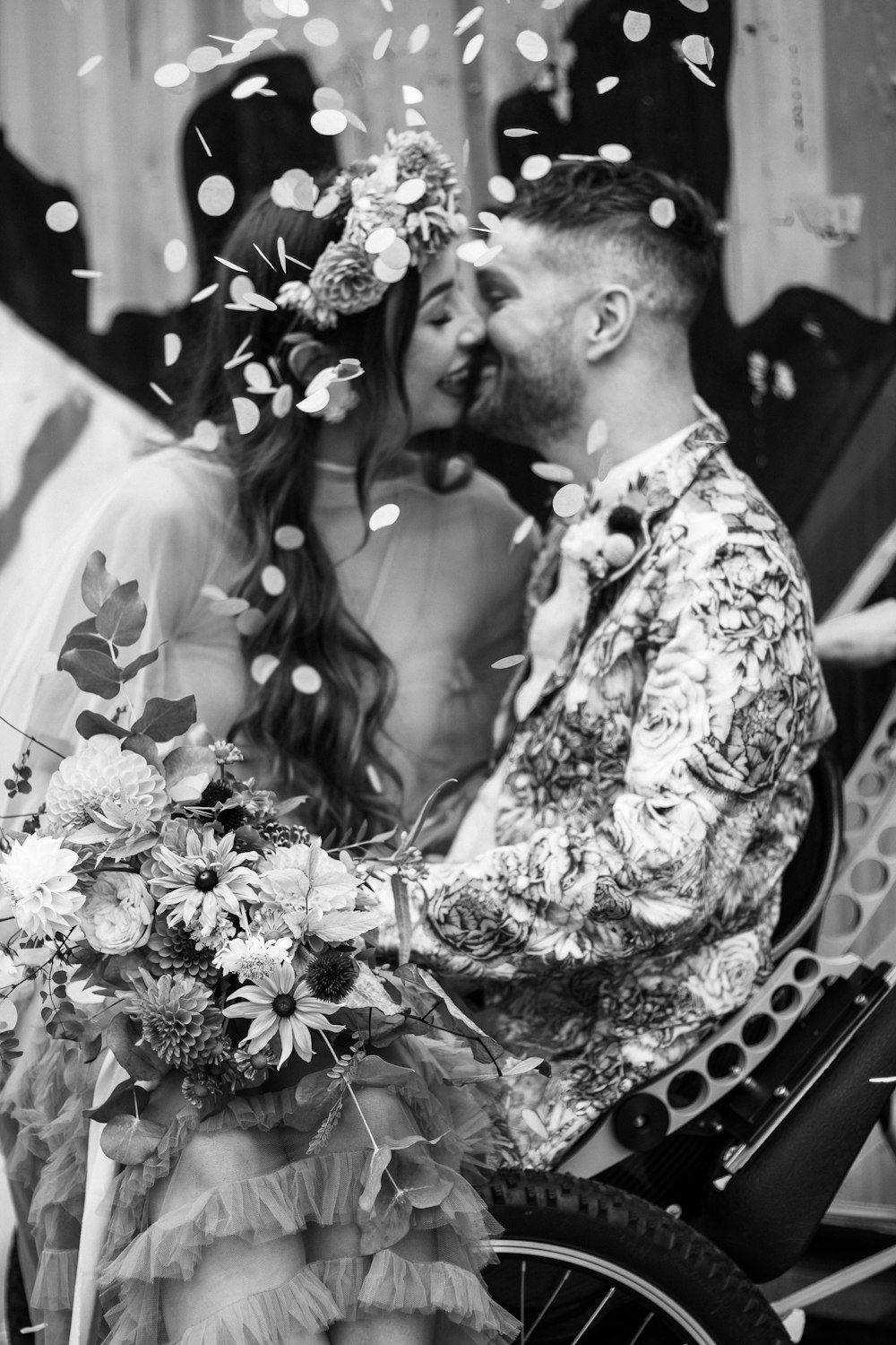 a man and woman kissing in front of a bicycle