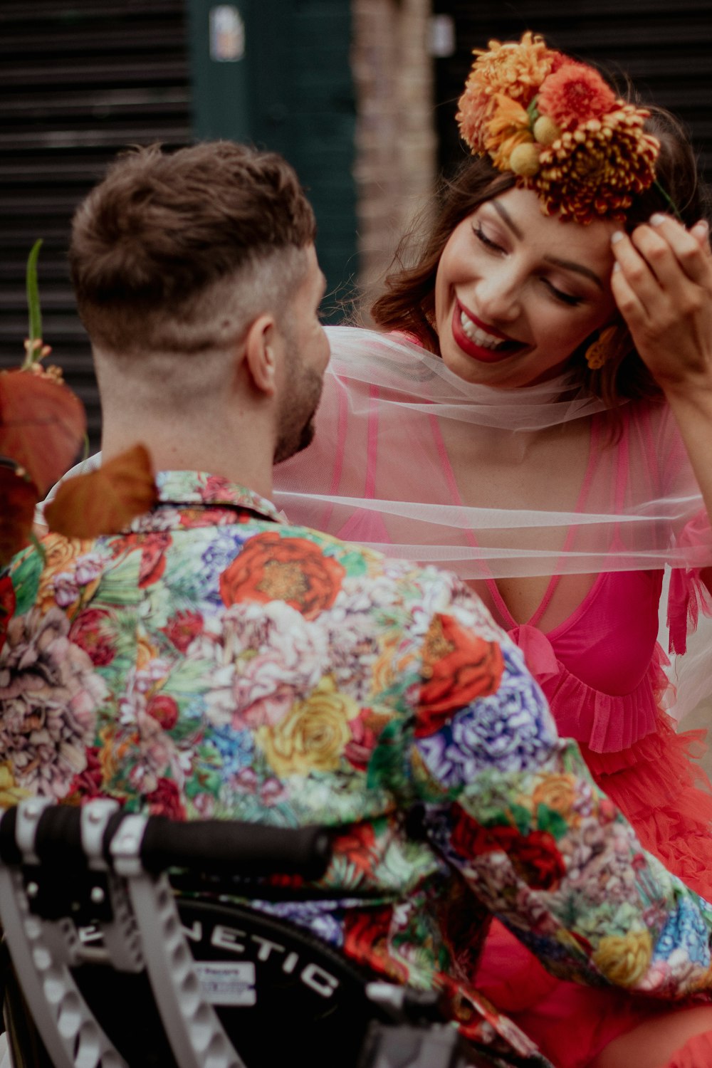 a man in a wheelchair with a flower crown on his head