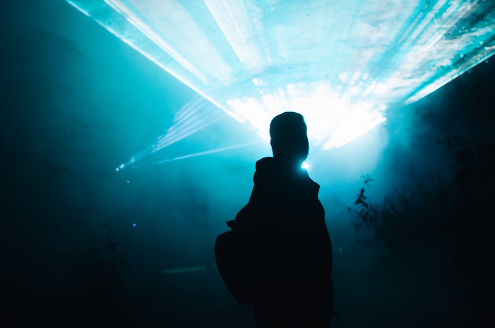 a silhouette of a person standing in front of a stage