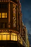 a building with a sign that says harrod lit up at night