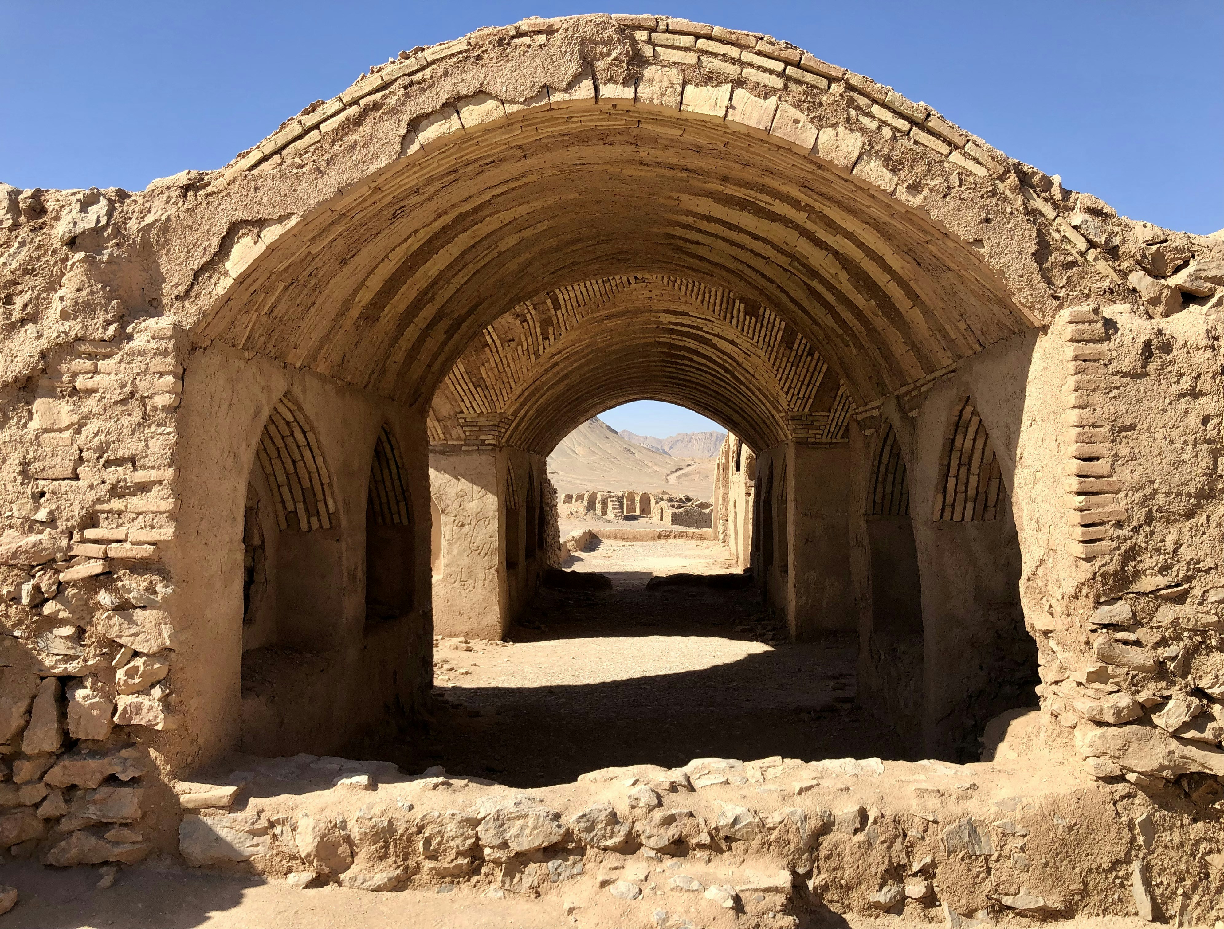 a stone tunnel with a sky background