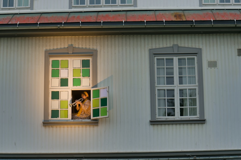 Una mujer está mirando por una ventana