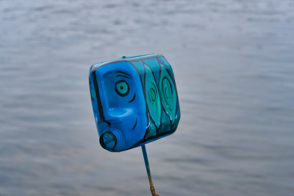 a toothbrush holder with a face painted on it