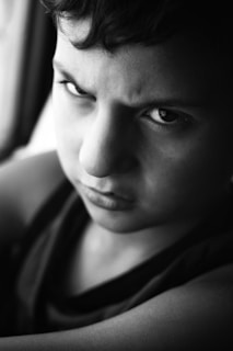 a black and white photo of a young boy