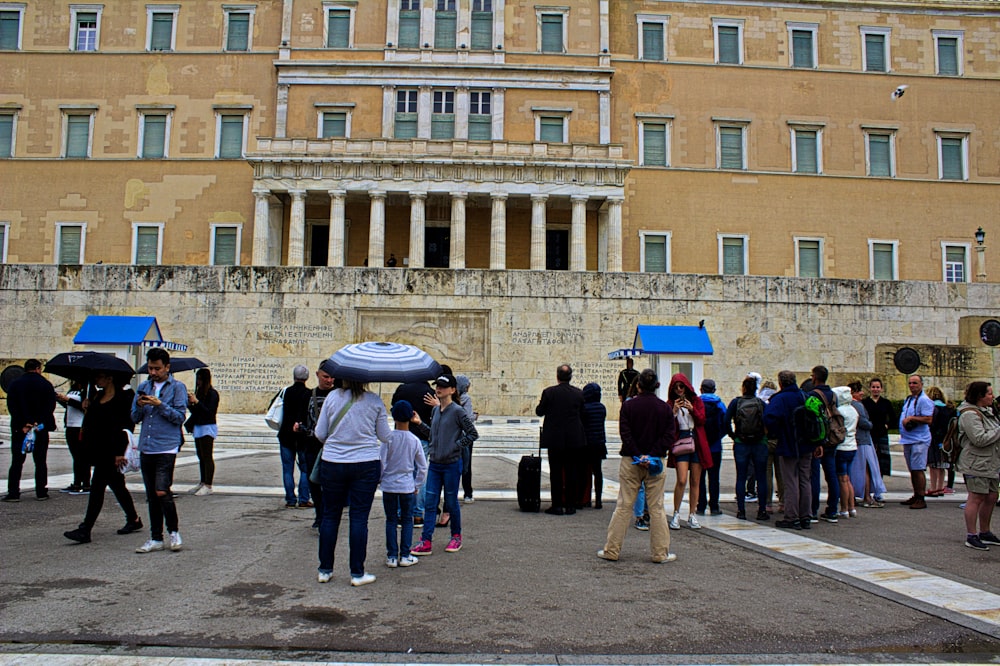 a group of people standing in front of a building