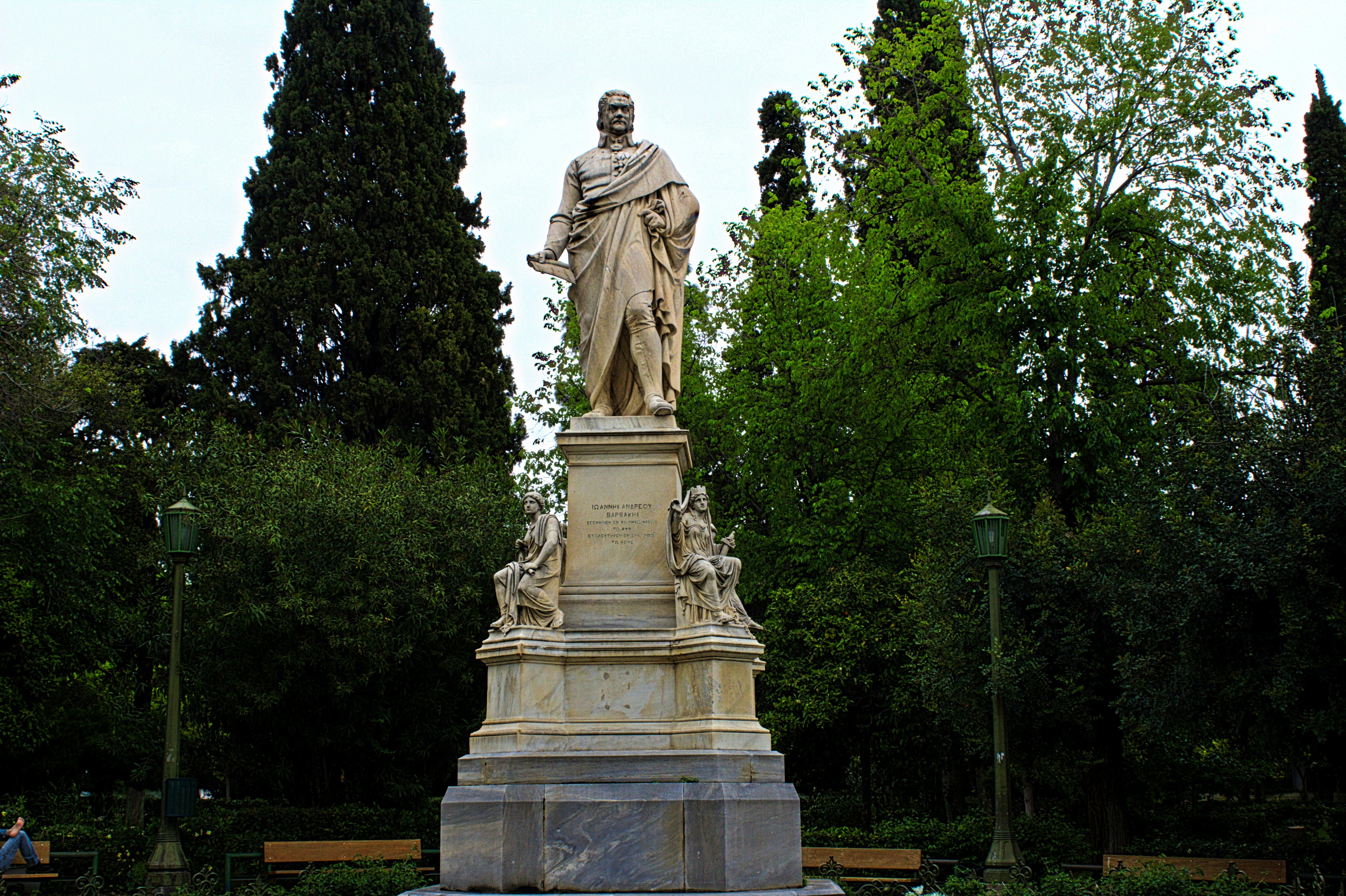 a statue of a man standing in a park