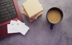 a cup of coffee sitting next to a laptop computer