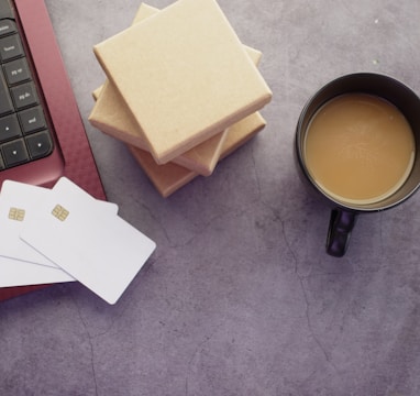 a cup of coffee sitting next to a laptop computer