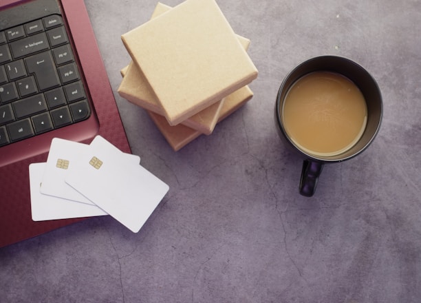 a cup of coffee sitting next to a laptop computer