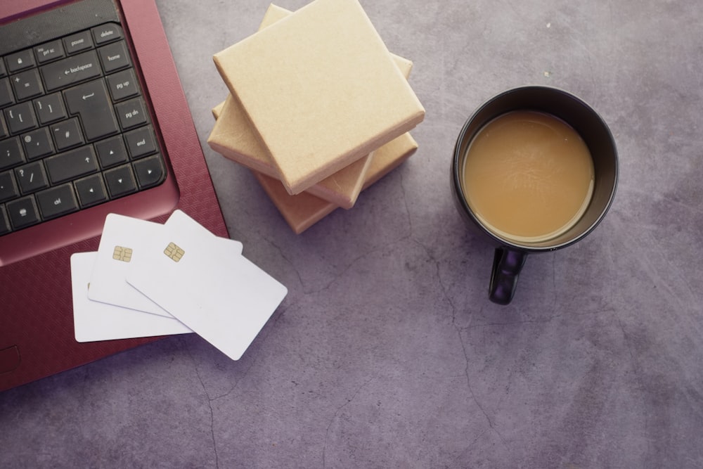 a cup of coffee sitting next to a laptop computer