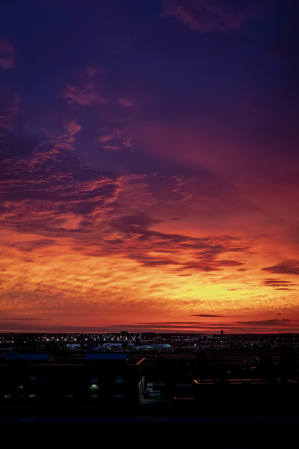 a plane is flying in the sky at sunset