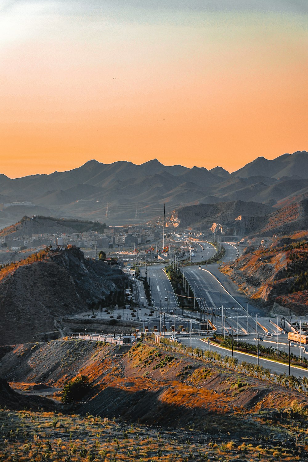 a view of a highway with mountains in the background