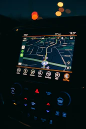 a car dashboard with a gps device in the middle of it