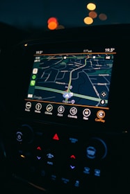 a car dashboard with a gps device in the middle of it