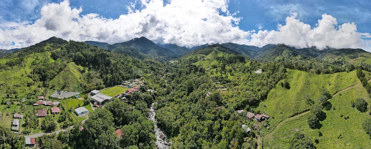 an aerial view of a village surrounded by mountains