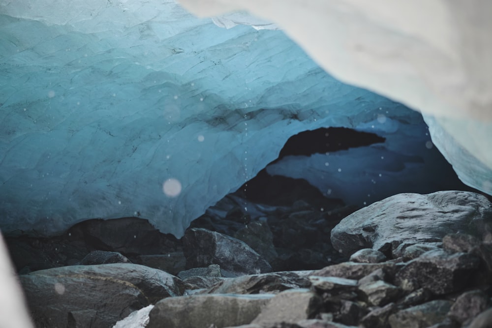 a large ice cave with rocks and water