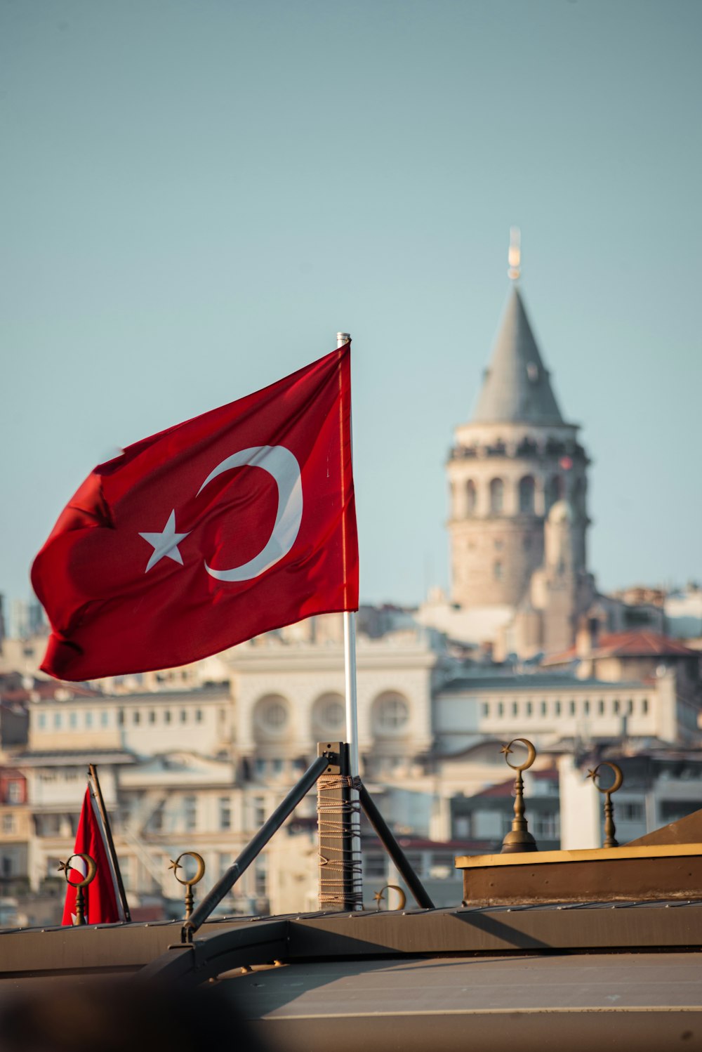 a flag flying in front of a large building