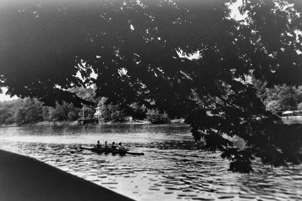 a black and white photo of some people in a boat