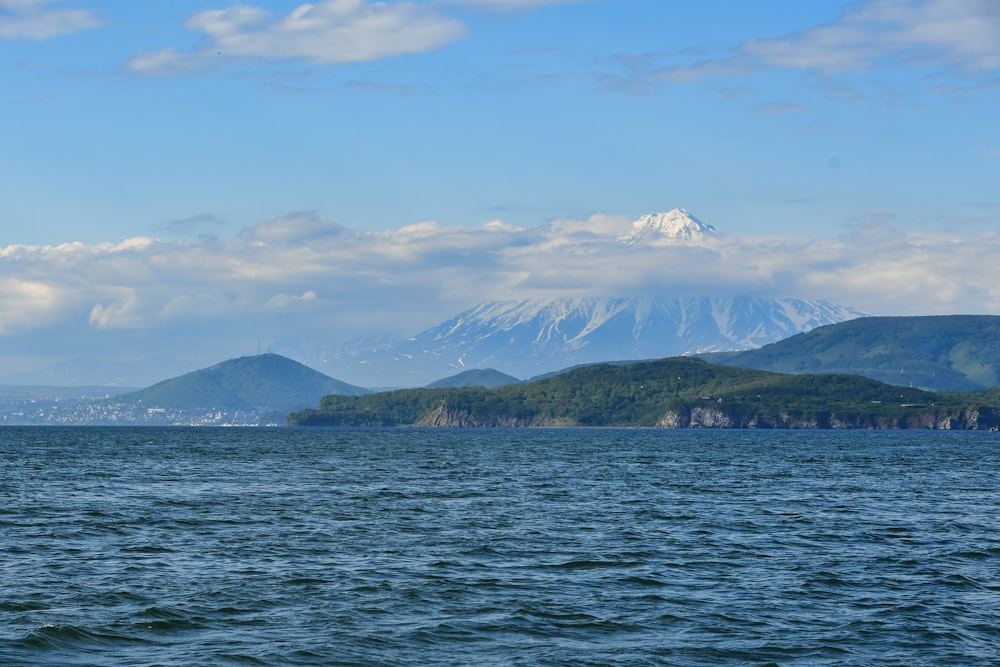 a large body of water with mountains in the background