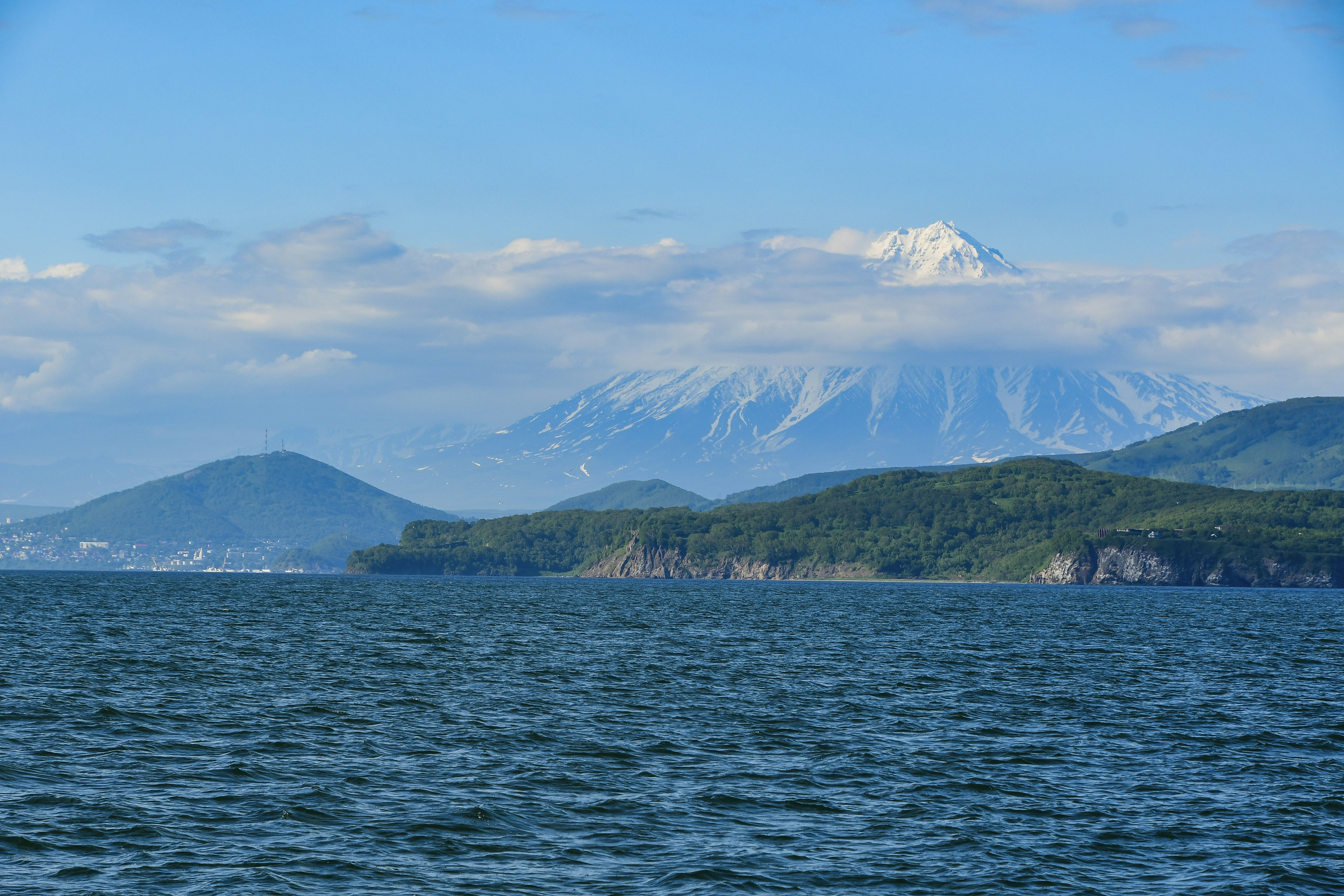 a large body of water with mountains in the background
