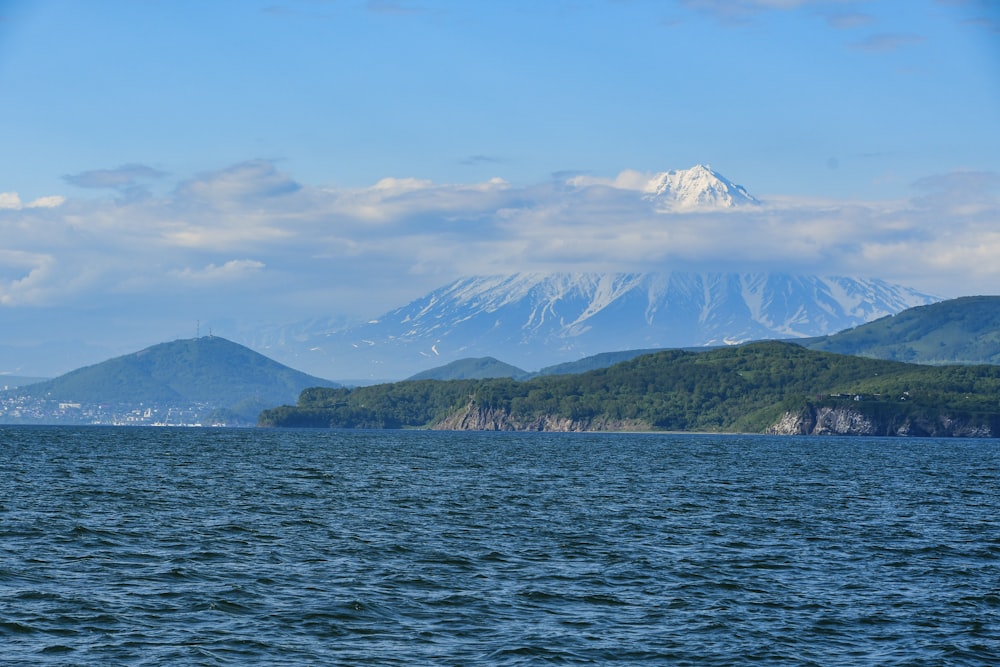 a large body of water with mountains in the background