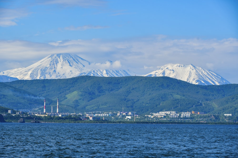 a large body of water with a mountain in the background