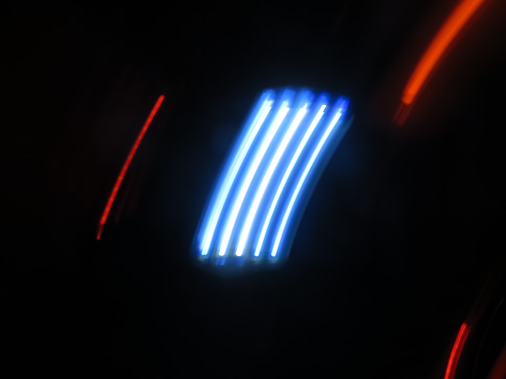 a close up of a neon light in the dark