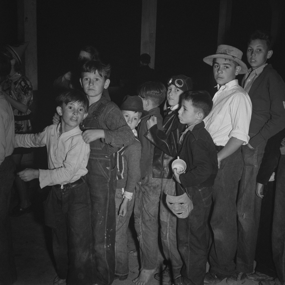 a group of young boys standing next to each other