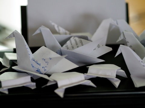 a pile of origami birds sitting on top of a table
