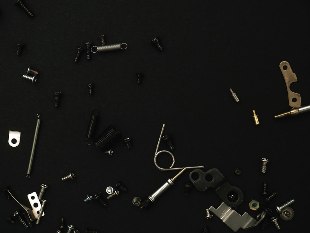 a bunch of different types of hardware on a black surface
