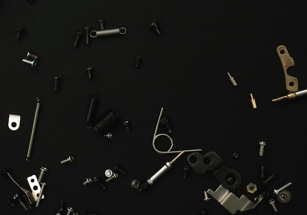 a bunch of different types of hardware on a black surface