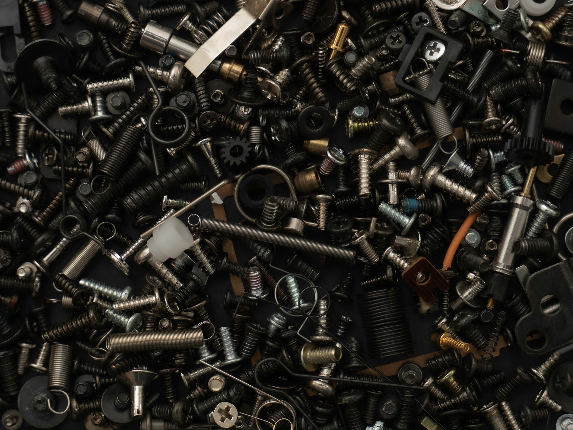a pile of assorted screws and nuts