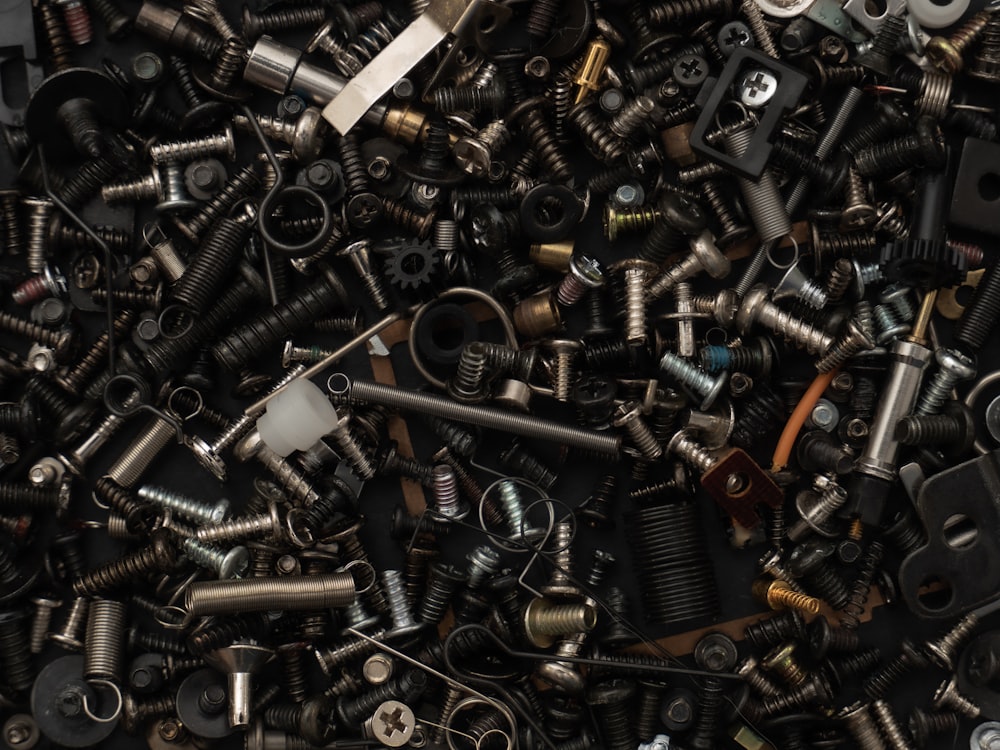 a pile of assorted screws and nuts
