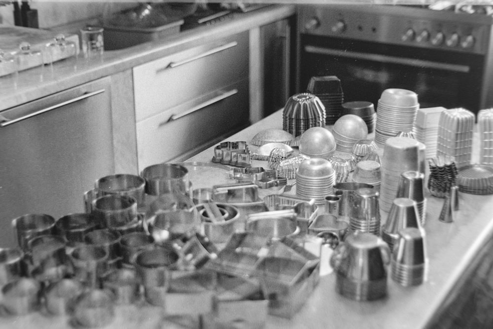 a kitchen counter topped with lots of pots and pans