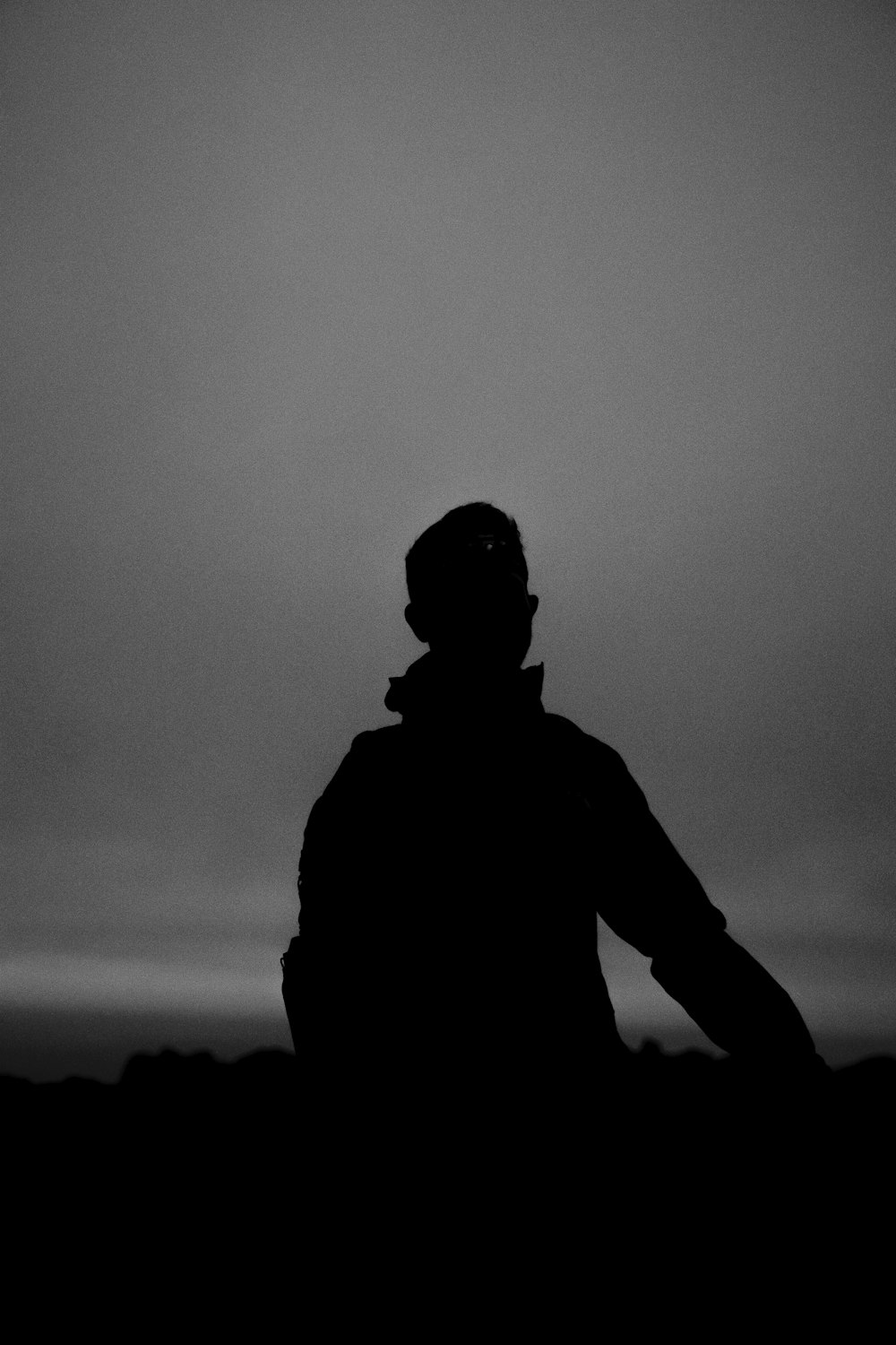 a person standing in the dark with a frisbee in their hand