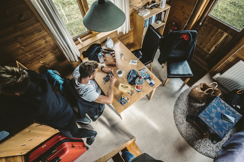 a group of people sitting around a wooden table