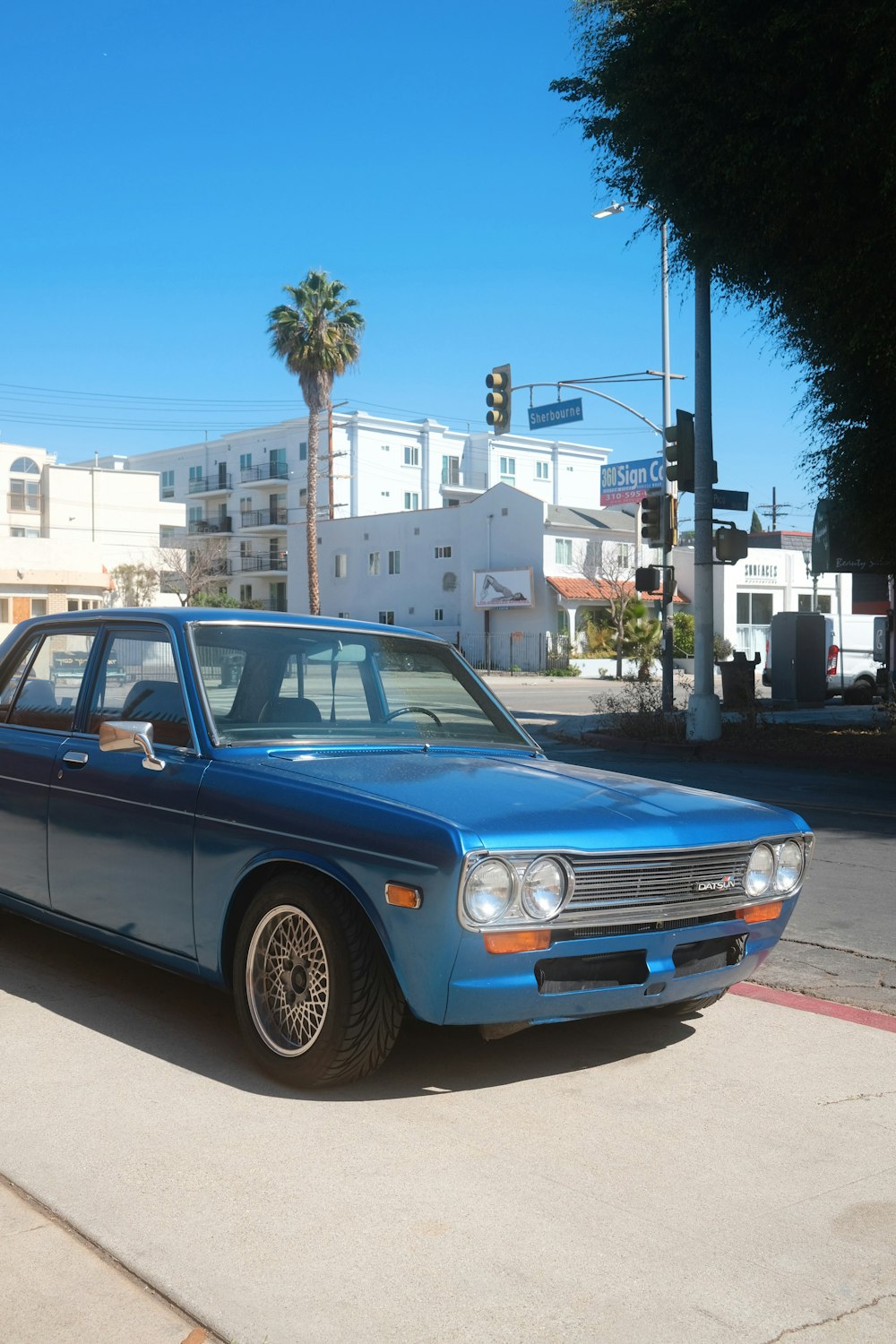 a blue car parked on the side of the road