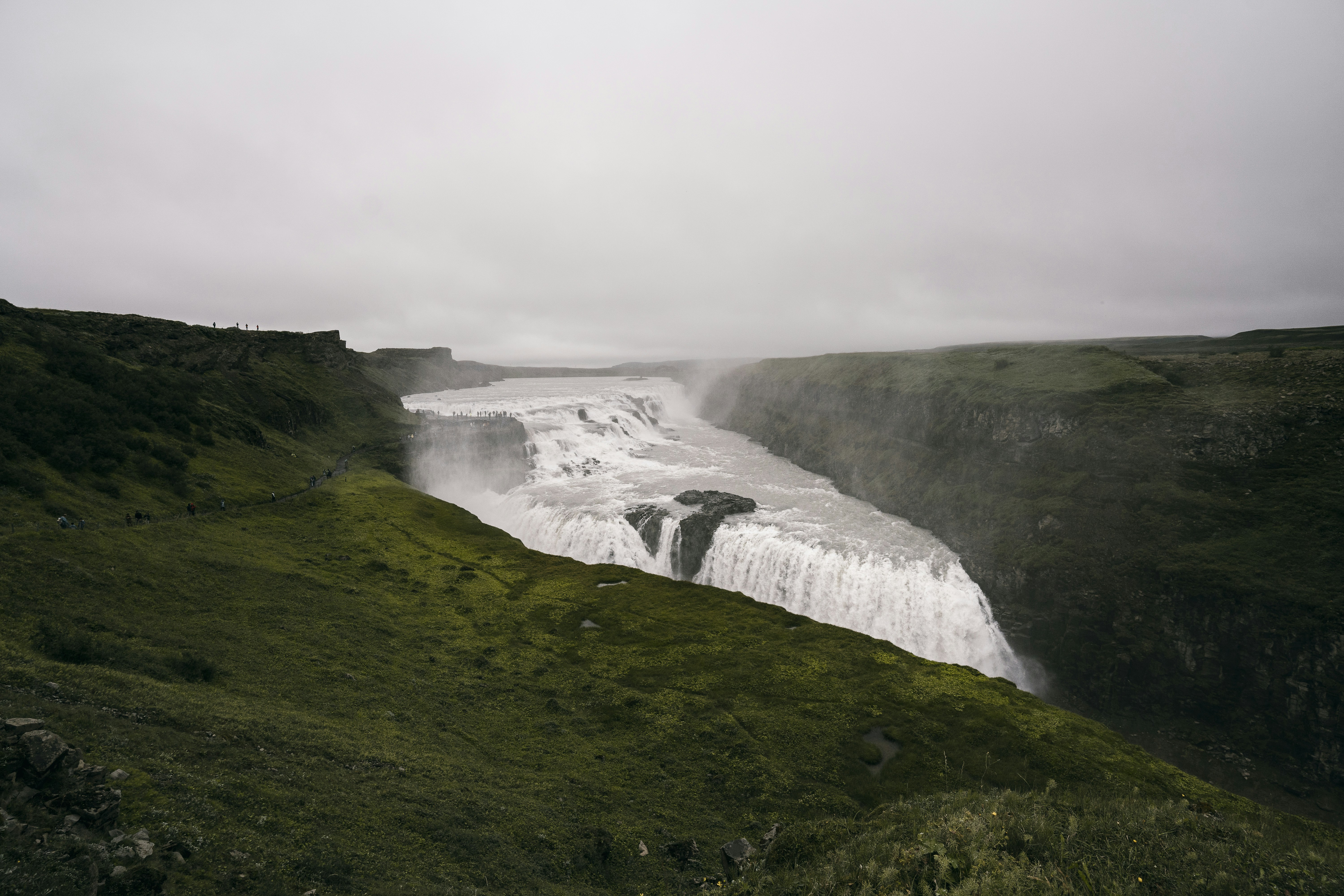 a view of a waterfall in the middle of a field