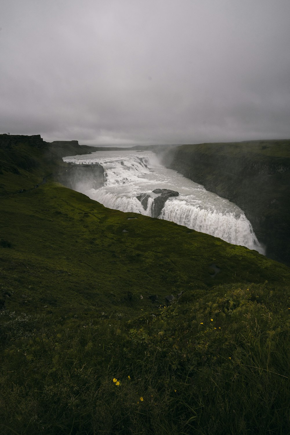 a large waterfall in the middle of a field