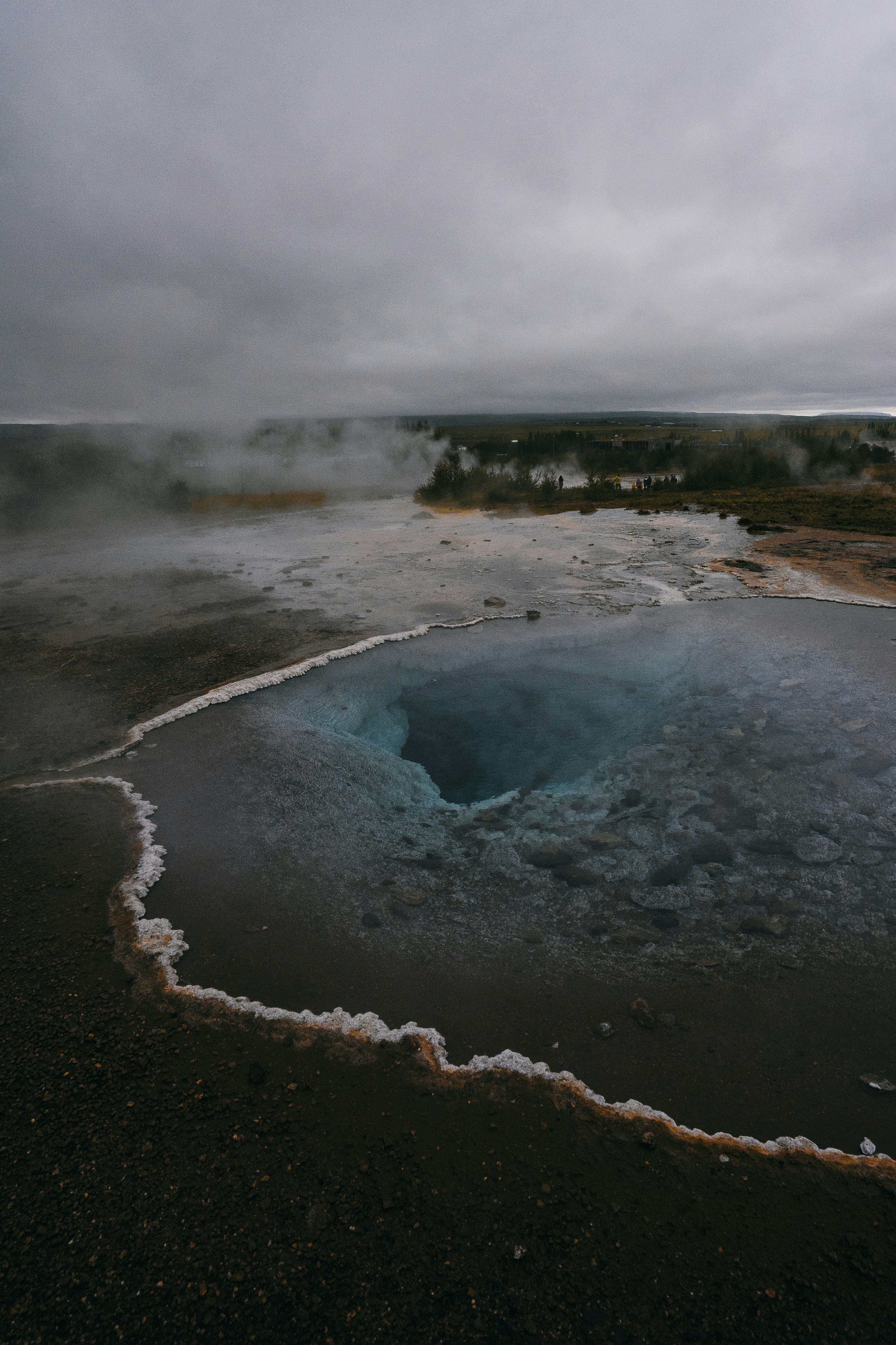 a body of water with steam rising from it