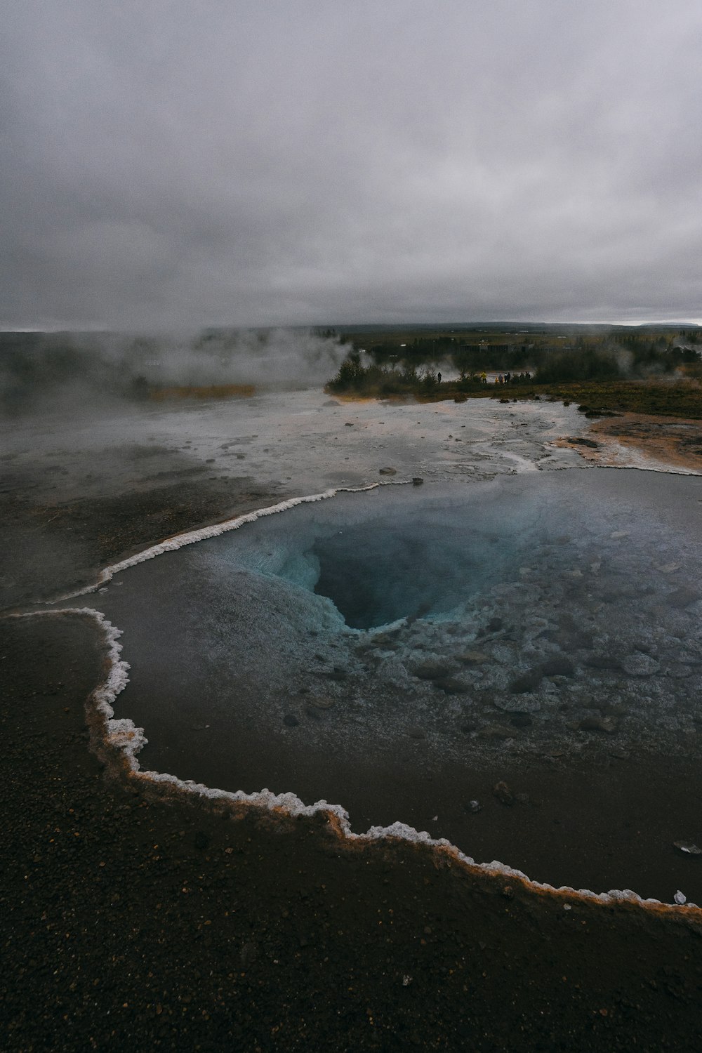 a body of water with steam rising from it
