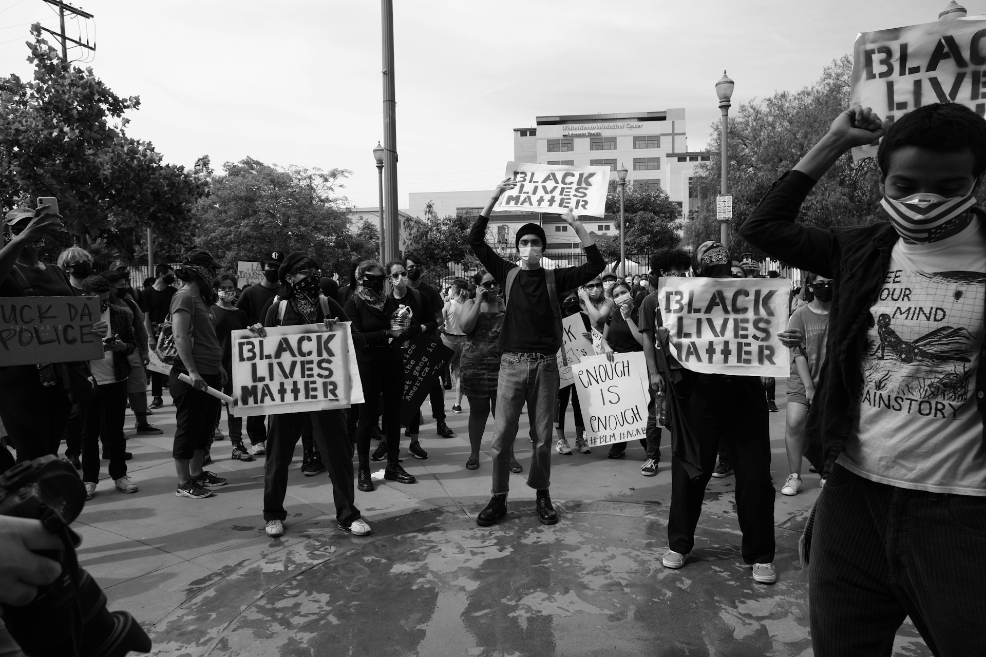a group of people holding up signs in the street