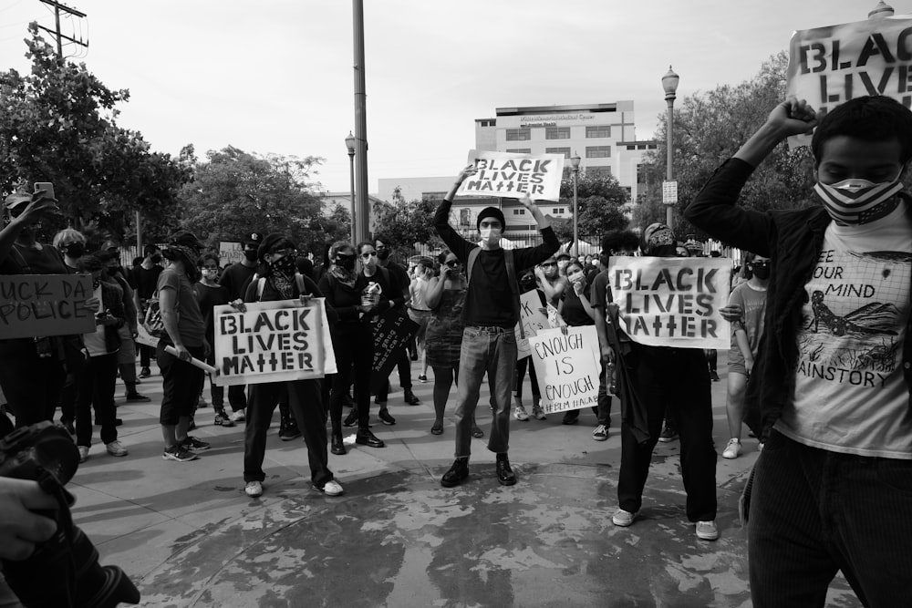 a group of people holding up signs in the street