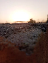 Close-up macro shot of circadian lighting transitioning from warm amber to cool daylight over textured concrete.