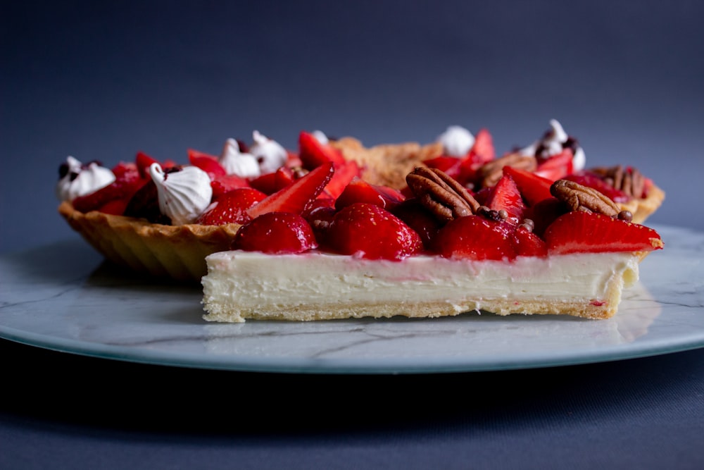 a piece of pie with strawberries and pecans on top