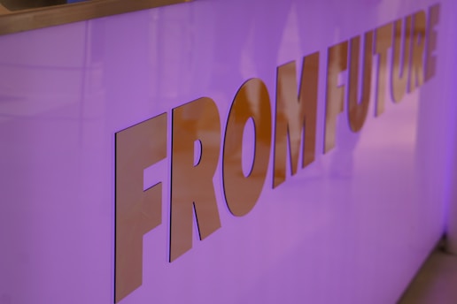 The image features a close-up view of a purple-lit surface with the words 'FROM FUTURE' embossed in large metallic letters.
