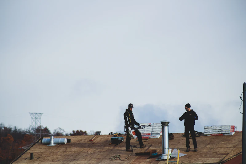 Commercial flat roofing crew working on a low-slope membrane roof