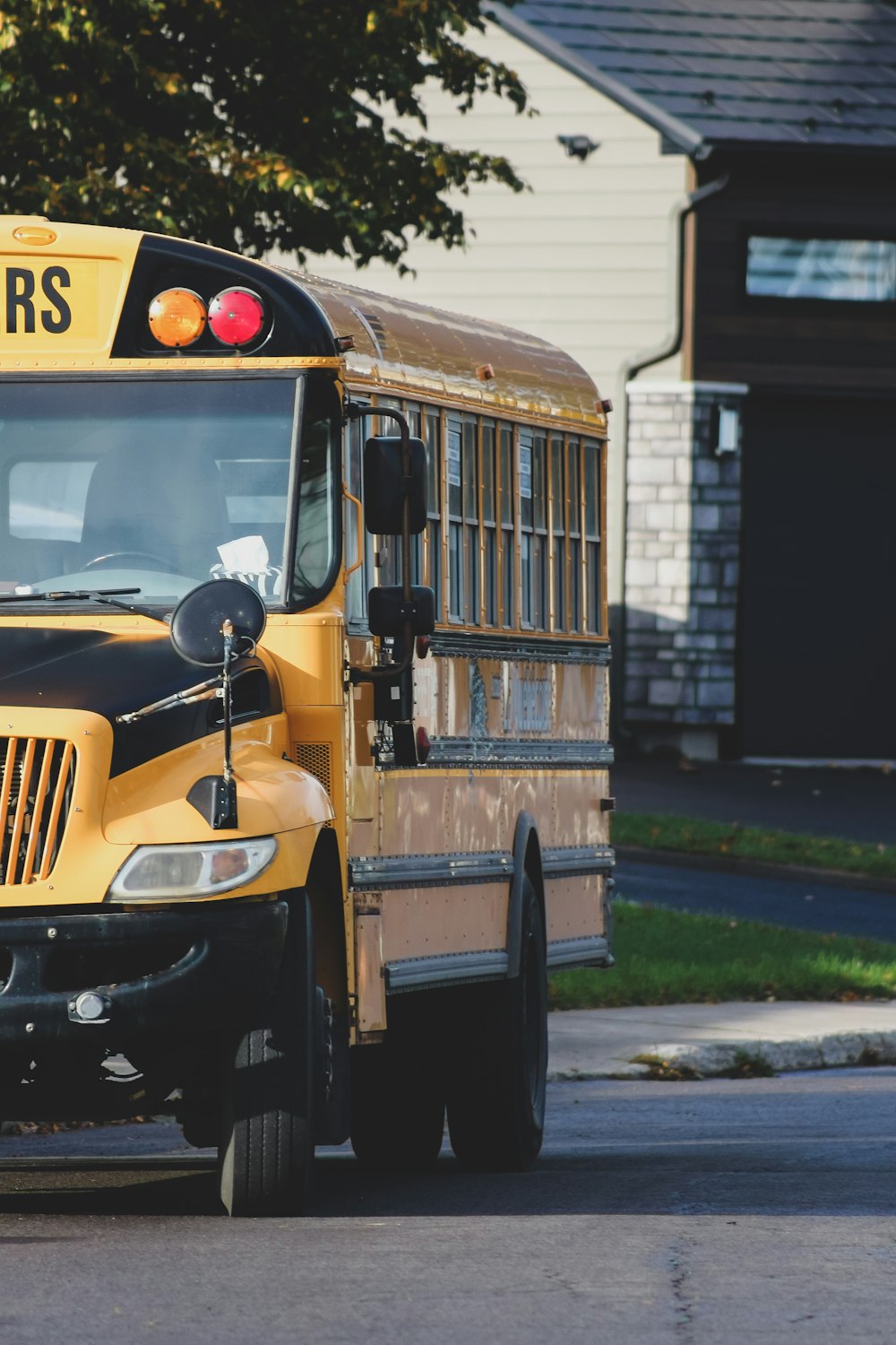 a yellow school bus driving down a street