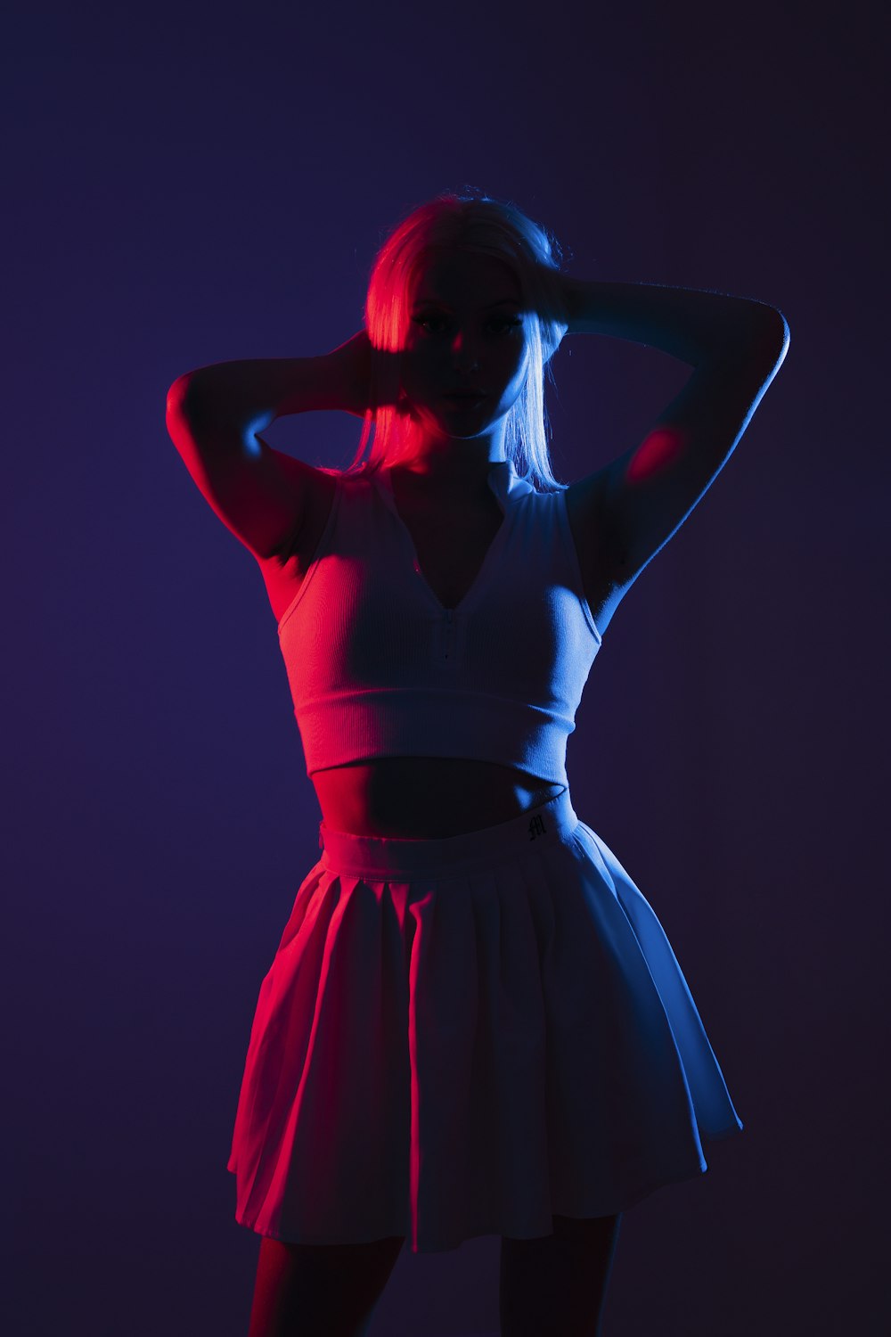 a woman in a white dress is posing for a picture